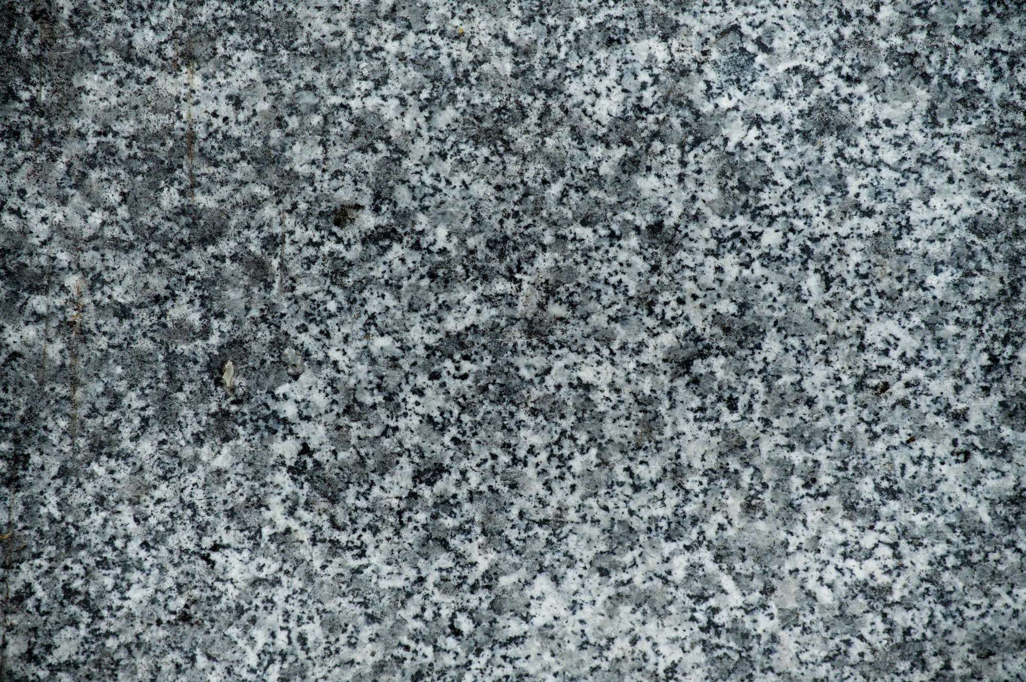Close detail of a blue grey granite surface showing an even speckled crystal structure