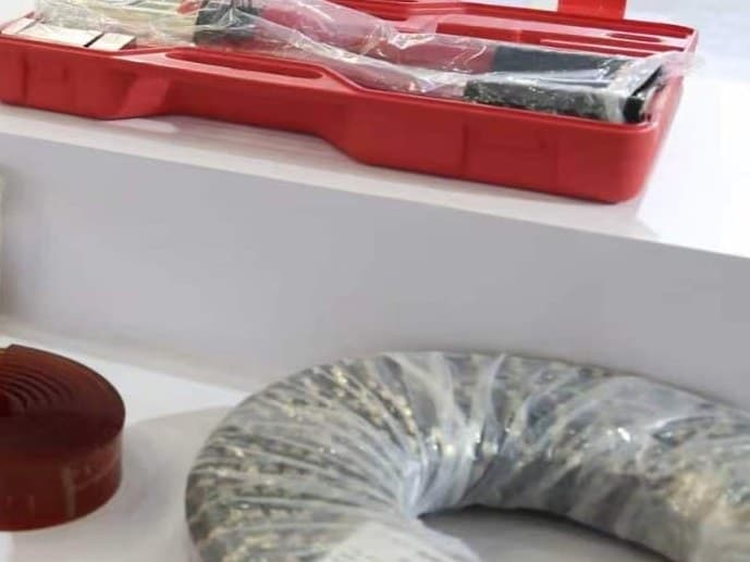 A wire jointing tool case open beside a coil of diamond wire